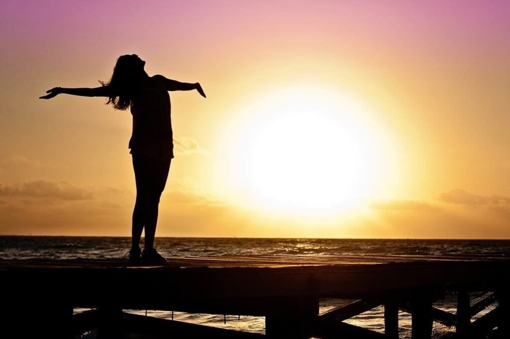 What Is Christianity? 9 Girl thanking Jesus by the ocean