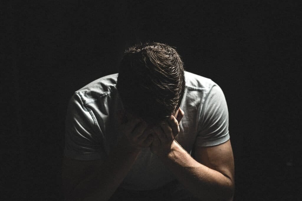 What Is Christianity? 4 sad man with his hands against his head